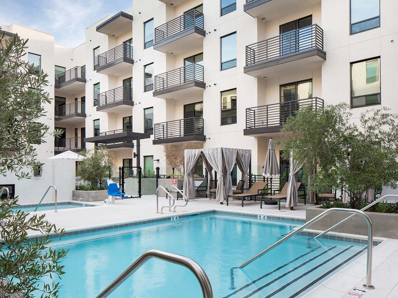 a swimming pool in front of an apartment building